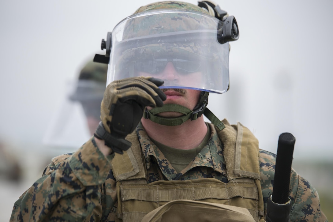 Cpl. Tyrel Phillips, a military policeman with 4th Law Enforcement Battalion, Force Headquarters Group, Marine Forces Reserve, pulls down his visor before presenting his shield while training in a class on crowd control during exercise Platinum Wolf 2016 at Peacekeeping Training Operations Center South Base in Bujanovac, Serbia, May 12, 2016. Platinum Wolf brings together service members from Bosnia, Bulgaria, Macedonia, Montenegro, Serbia, Slovenia, and the United States, it aims to build interoperability between the partnering nations and promote regional stability. (U.S. Marine Corps photo by Sgt. Sara Graham)