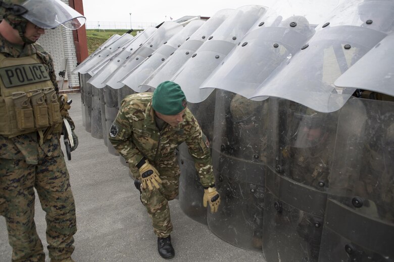 Staff Sgt. Ivan Collautti, a military policeman and crowd control instructor from Slovenia, checks the integrity of the defensive shell the Marines of 4th Law Enforcement Battalion, Force Headquarters Group, Marine Forces Reserve, made during exercise Platinum Wolf 2016 at Peacekeeping Training Operations Center South Base in Bujanovac, Serbia, May 12, 2016. Platinum Wolf brings together service members from Bosnia, Bulgaria, Macedonia, Montenegro, Serbia, Slovenia, and the United States to train in peacekeeping operations and non-lethal weapons capabilities. (U.S. Marine Corps photo by Sgt. Sara Graham)