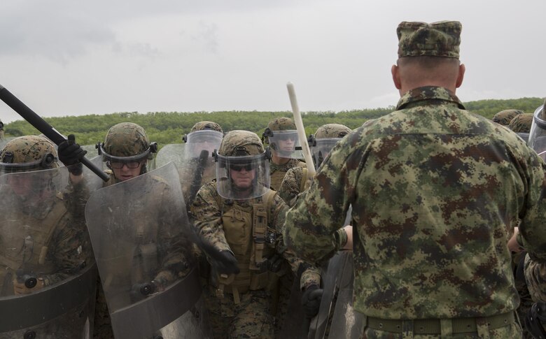 Reserve Marines with 4th Law Enforcement Battalion, Force Headquarters Group, Marine Forces Reserve, practice striking while taking a class on crowd control, taught by Slovenian and Serbian service members, during exercise Platinum Wolf 2016 at the Peacekeeping Training Operations Center South Base in Bujanovac, Serbia, May 12, 2016. Platinum Wolf brings together service members from Bosnia, Bulgaria, Macedonia, Montenegro, Serbia, Slovenia, and the United States to train in peacekeeping operations and non-lethal weapons capabilities. (U.S. Marine Corps photo by Sgt. Sara Graham)