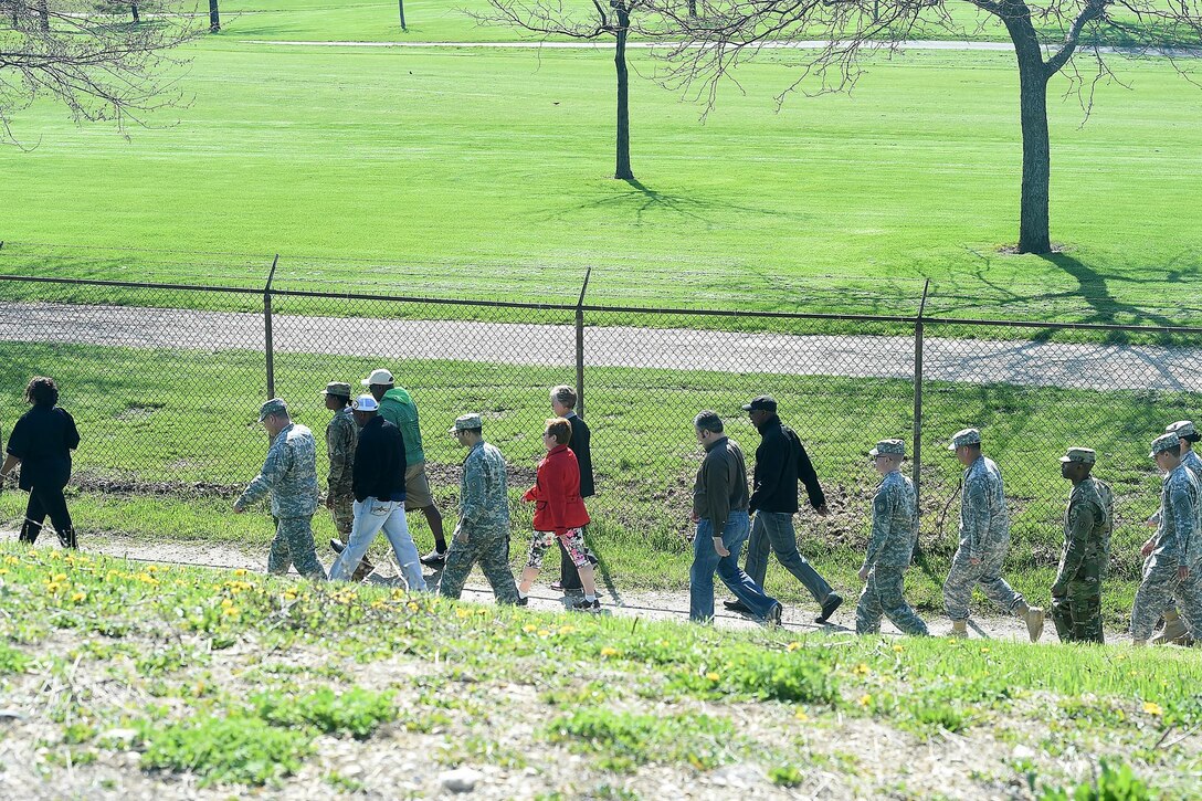 Soldiers and civilians assigned to the 85th Support Command walk the installation grounds with civilians from Defense Contract Management Agency-Chicago during a "Walk a Mile in Her Shoes," event hosted by the command's Sexual Assault Response Coordinator (SARC) to help raise awareness against sexual assaults. During the walk, the lead tested the participants knowledge in SHARP by creating two teams and challenging questions and providing additional insight on procedures to take for sexual assault victims.
(Photo by Sgt. 1st Class Anthony L. Taylor)