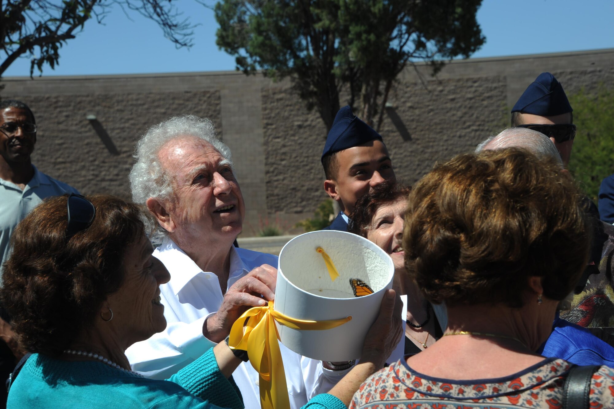 Pawel Lichter and additional Holocaust survivors release butterflies during the Holocaust Day of Remembrance at Davis-Monthan Air Force Base, Ariz., May 9, 2016. The ceremony concluded outside with the release of butterflies as a symbol of hope. (U.S. Air Force photo by Airman Nathan H. Barbour)