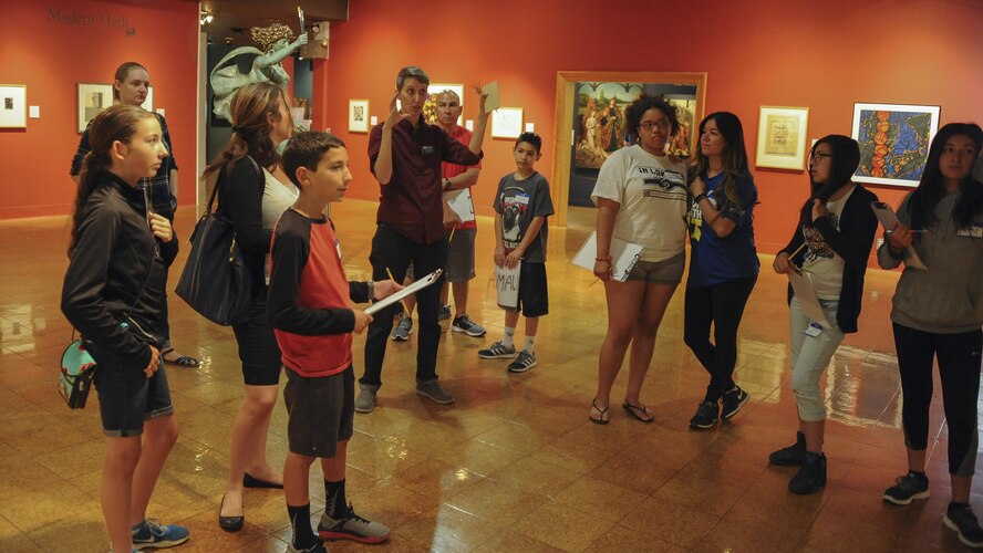 Chelsea Ferrar, University of Arizona Museum of Art assistant curator of education, speaks to military families during Month of the Military Child Family Art Series: Creative Explorations for Hope at UAMA in Tucson, Ariz., April 30, 2016. The series invited all branches of active duty military families to participate in touring exhibitions and attending art tutorials free of charge. (U.S. Air Force photo by Airman 1st Class Mya M. Crosby/Released)