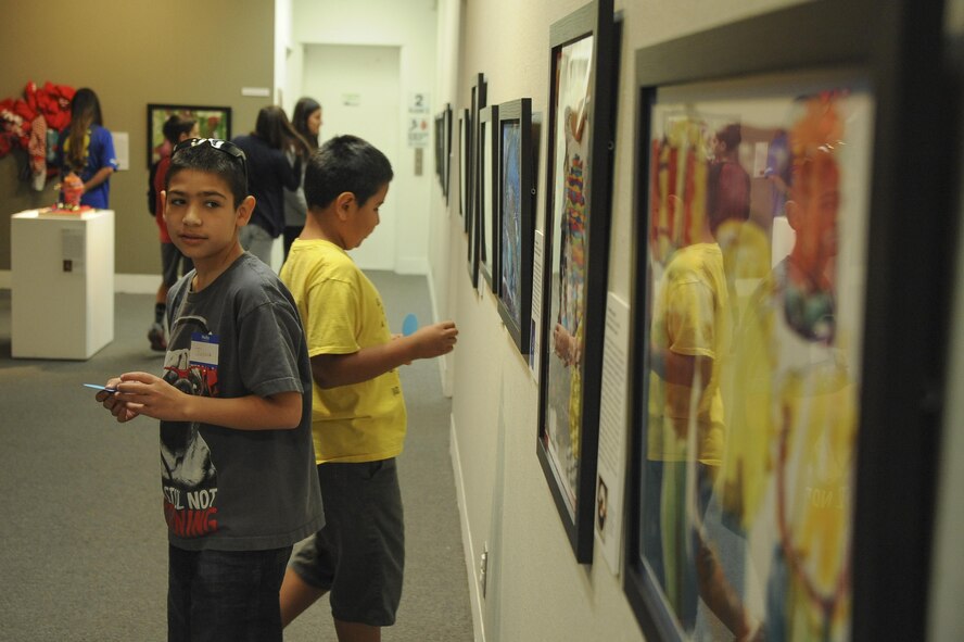 Joshua and Jacob Cardenas observe an art exhibit during Month of the Military Child Family Art Series: Creative Explorations for Hope at the University of Arizona Museum of Art in Tucson, Ariz., April 30, 2016. The art was created by artists from ArtWorks, a program under the university and community art space for adults with intellectual and developmental disabilities. (U.S. Air Force photo by Airman 1st Class Mya M. Crosby/Released)