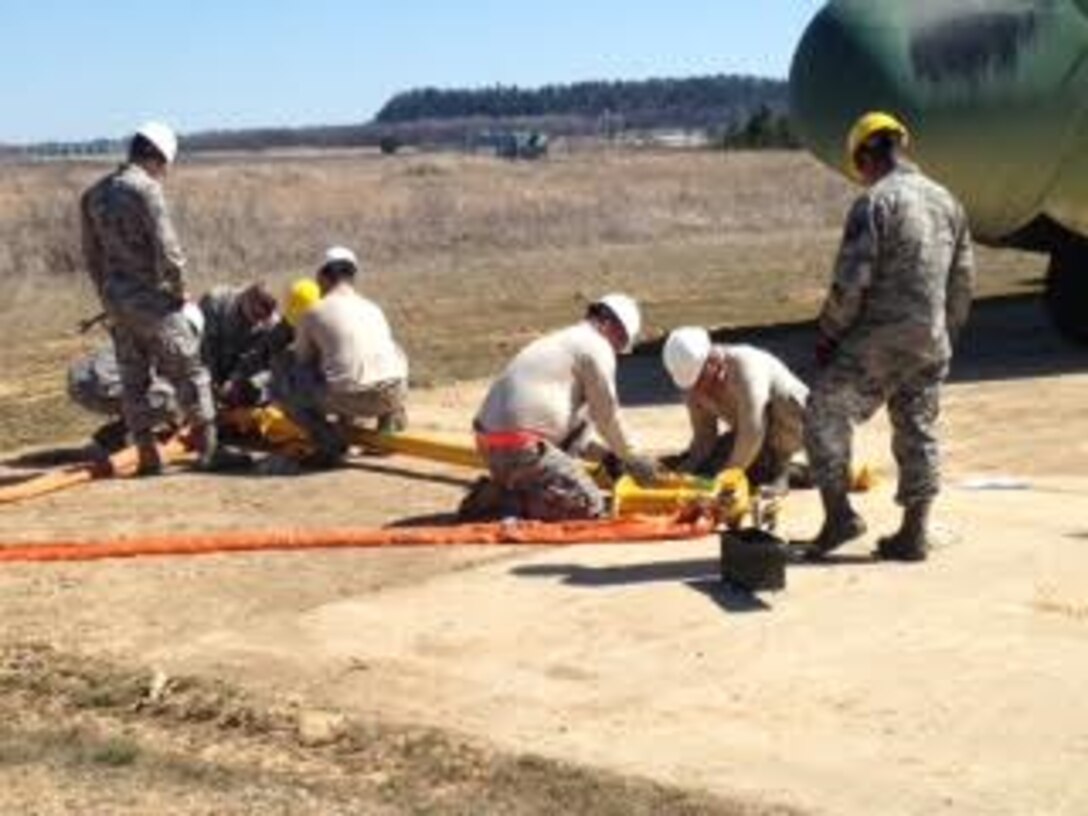 Maintenance Airmen prepare slings to attach to a C-130 Hercules for a “de-bog” during a Crash Damaged or Disabled Aircraft Recovery exercise April 11, 2016, at Volk Field Air National Guard Base, Wis. Multiple units came together to build professional working relationships while accomplishing a common goal. (Courtesy photo by Master Sgt. Gregory Mitchell)