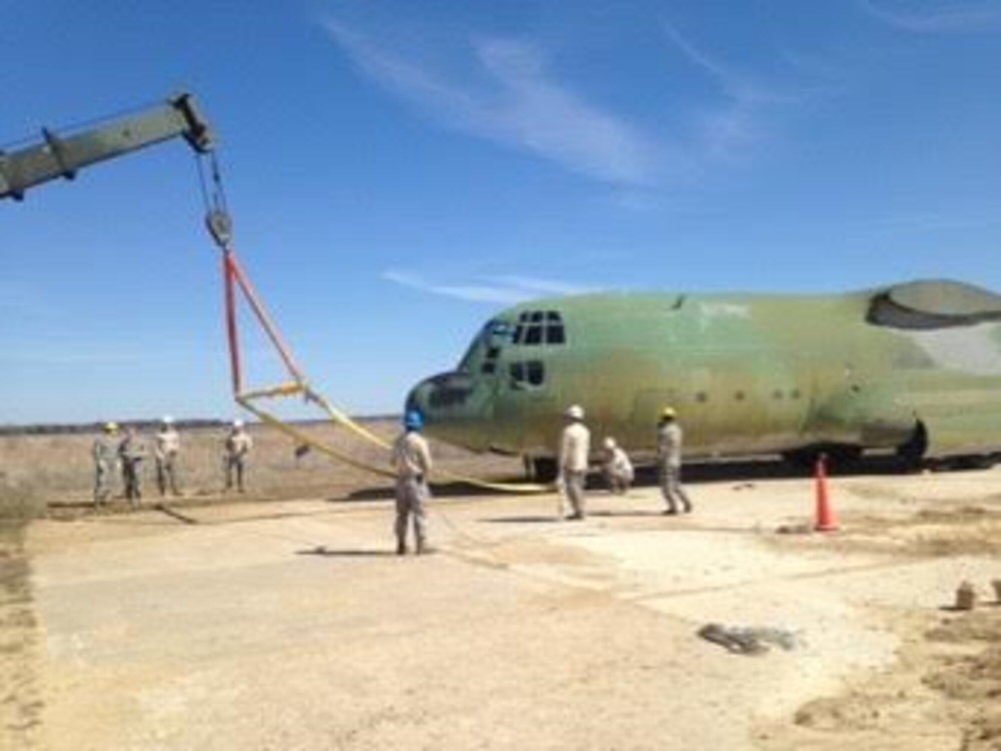 Maintenance Airmen prepare to “de-bog” a C-130 Hercules during a Crash Damaged or Disabled Aircraft Recovery exercise April 11, 2016, at Volk Field Air National Guard Base, Wis. Removing Aircraft from various terrains requires a wide-array of procedures and applications of force. (Courtesy photo by Master Sgt. Gregory Mitchell)