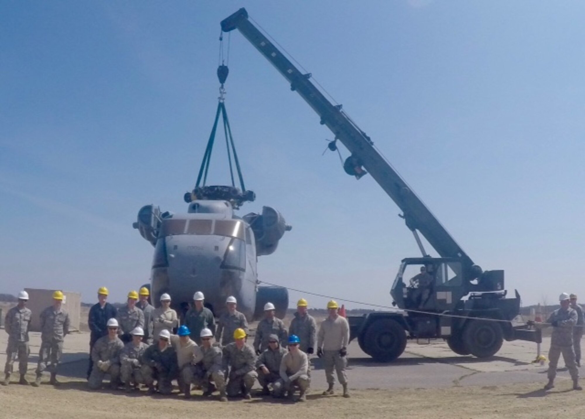 Maintenance Airmen pose in front of a CH-53 Sea Stallion helicopter during a Crash Damaged or Disabled Aircraft Recovery exercise April 11, 2016, at Volk Field Air National Guard Base, Wis.  The joint exercise provided multiple units valuable, hands-on experience. (Courtesy photo by Master Sgt. Gregory Mitchell)
