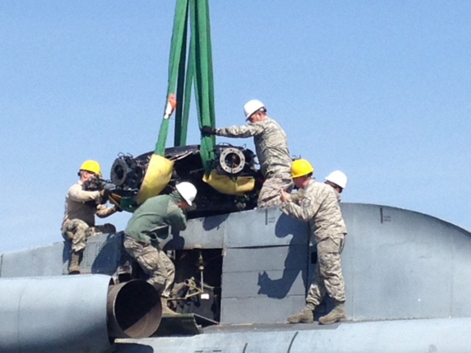 Maintenance Airmen attach lifting slings to the rotor of a CH-53 Sea Stallion helicopter during a Crash Damaged or Disabled Aircraft Recovery exercise April 11, 2016, at Volk Field Air National Guard Base, Wis. Multiple units had to work together to lift an unfamiliar airframe. (Courtesy photo by Master Sgt. Gregory Mitchell)