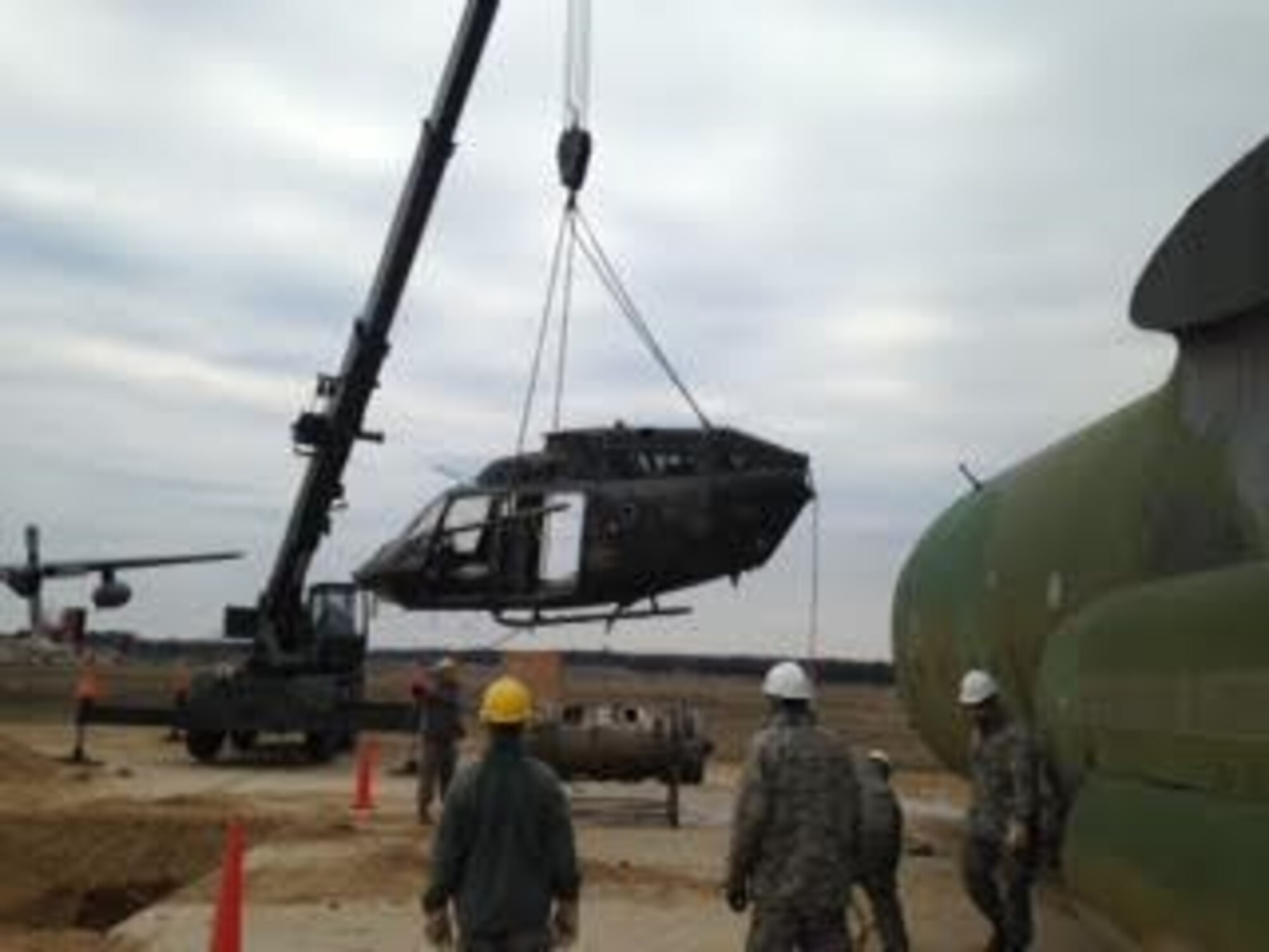 Maintenance Airmen lift a CH-53 Sea Stallion helicopter during a Crash Damaged or Disabled Aircraft Recovery exercise April 11, 2016, at Volk Field Air National Guard Base, Wis. Lifting a helicopter poses distinct challenges from fixed-wing aircraft due to a difference in their centers of gravity. (Courtesy photo by Master Sgt. Gregory Mitchell)