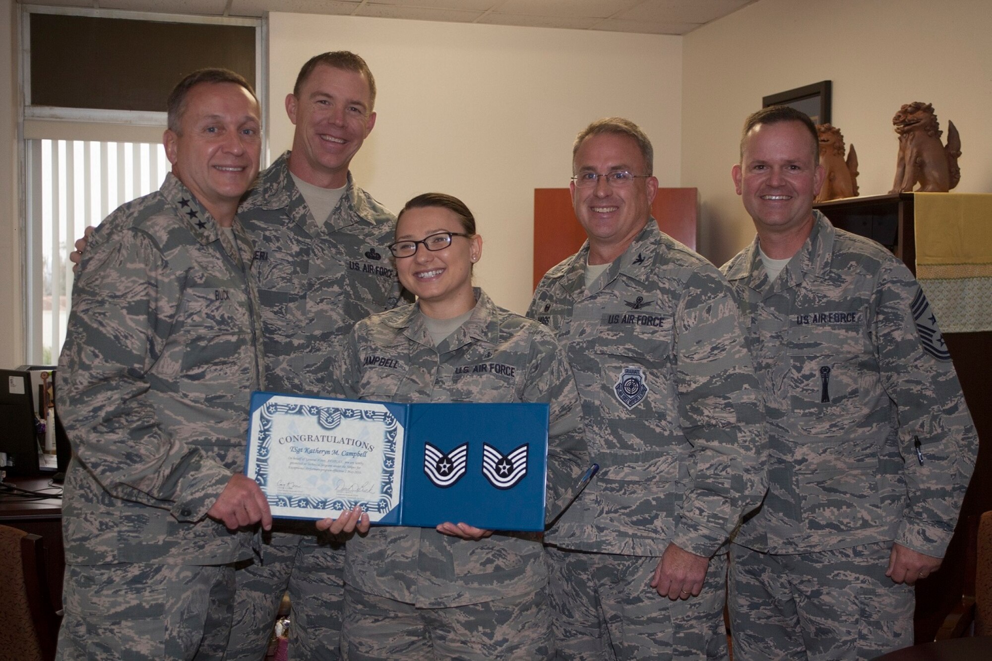 Staff Sgt. Katheryn Campbell, 30th Medical Support Squadron medical readiness flight chief, poses with Lt. Gen. David J. Buck, Commander, 14th Air Force (Air Forces Strategic), Air Force Space Command; and Commander, Joint Functional Component Command for Space, U.S. Strategic Command, Chief MSgt. Craig Neri, Command Chief Master Sergeant, 14th Air Force (Air Forces Strategic), Air Force Space Command; and Command Senior Enlisted Leader, Joint Functional Component Command for Space, U.S. Strategic Command, Col. J. Christopher Moss, Commander 30th Space Wing, and Chief MSgt. Robert Bedell, 30th Space Wing command chief, after recently being selected for STEP promotion to technical sergeant, Vandenberg Air Force Base, Calif. Campbell is soon leaving Vandenberg to take the next step in her career - becoming a bioenvironmental technical school instructor at Wright-Patterson Air Force Base. 