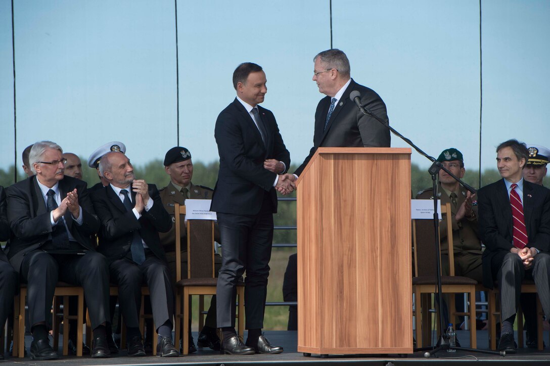 Deputy Defense Secretary Bob Work shakes hands with Polish President Andrzej Duda during the Aegis Ashore ballistic missile defense site phase three groundbreaking ceremony in Redzikowo, Poland, May 13, 2016. DoD photo by Navy Petty Officer 1st Class Tim D. Godbee