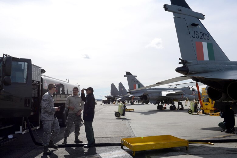 U.S. Air Force Tech. Sgt. Zachary Pletcher, the Noncommissioned Officer in Charge of Fuels Distribution for the 354th Logistics Readiness Squadron (LRS) enjoys a moment of levity with Airman 1st Class Manuel Huesca, a fuels distribution operator with the 18th LRS out of Kadena Air Base, Japan, and an Indian Air Force (IAF) airman while waiting for an IAF Jaguar aircraft with 14 Squadron deployed from Ambala Air Base, India, to finish fueling at Eielson Air Force Base, Alaska, May 4, 2016. (U.S. Air Force photo by Master Sgt. Karen J. Tomasik/Released)