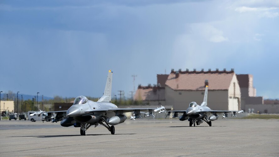 A pair of U.S. Air Force F-16 Fighting Falcons assigned to the 80th Fighter Squadron out of Kunsan Air Base, Republic of Korea, taxis down the Eielson Air Force Base, Alaska, flight line May 4, 2016, in preparation for a RED FLAG-Alaska (RF-A) 16-1 afternoon mission. RF-A is a series of Pacific Air Forces commander-directed field training exercises for U.S. and partner nation forces, enabling joint and international units to exchange tactics, techniques and procedures while improving interoperability in a realistic threat environment inside 67,000 square miles of expansive co-located air and land ranges known as the Joint Pacific Alaska Range Complex. (U.S. Air Force photo by Master Sgt. Karen J. Tomasik/Released)