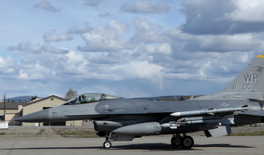 A U.S. Air Force F-16 Fighting Falcon pilot assigned to the 80th Fighter Squadron out of Kunsan Air Base, Republic of Korea, taxis down the Eielson Air Force Base, Alaska, flight line in a jet painted with the 8th Operations Group markings, May 4, 2016, in preparation for a RED FLAG-Alaska (RF-A) 16-1 afternoon mission. The Joint Pacific Alaska Range Complex provides units like the Wolf Pack access to a realistic training environment and allows commanders to train for full spectrum engagements ranging from individual skills to complex, large-scale joint engagements. (U.S. Air Force photo by Master Sgt. Karen J. Tomasik/Released)