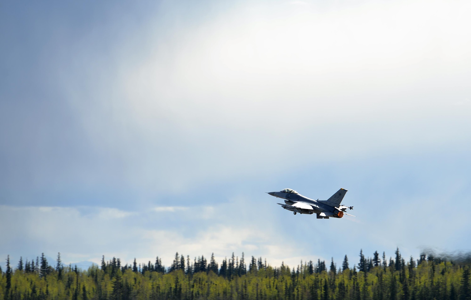 A U.S. Air Force F-16 Fighting Falcon assigned to the 80th Fighter Squadron out of Kunsan Air Base, Republic of Korea, takes off from Eielson Air Force Base, Alaska, under semi-cludy skies May 4, 2016, during RED FLAG-Alaska (RF-A) 16-1. RF-A is a series of Pacific Air Forces commander-directed field training exercises for U.S. and partner nation forces, enabling joint and international units to exchange tactics, techniques and procedures while improving interoperability in a realistic threat environment inside 67,000 square miles of expansive co-located air and land ranges known as the Joint Pacific Alaska Range Complex. (U.S. Air Force photo by Master Sgt. Karen J. Tomasik/Released)
