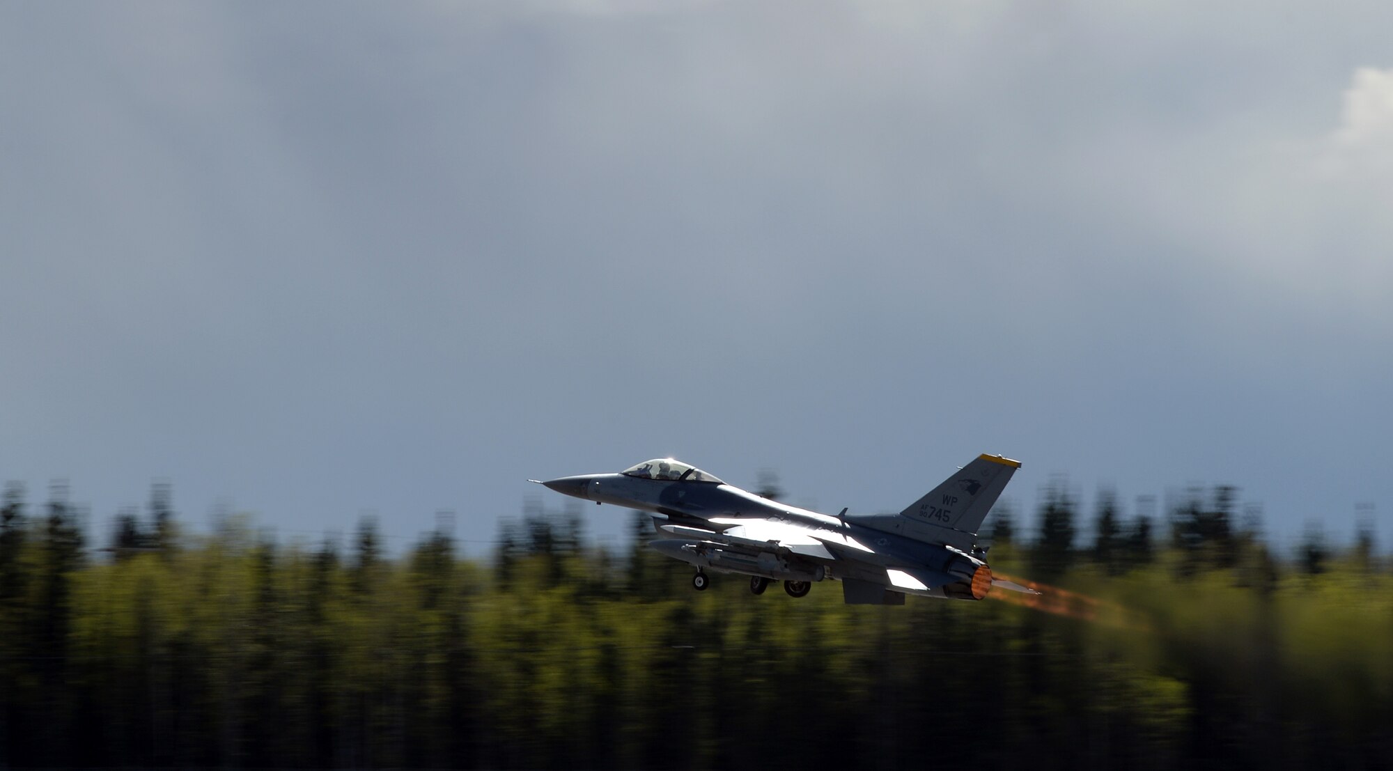 A U.S. Air Force F-16 Fighting Falcon assigned to the 80th Fighter Squadron out of Kunsan Air Base, Republic of Korea, takes off from Eielson Air Force Base, Alaska, under semi-cludy skies May 4, 2016, during RED FLAG-Alaska (RF-A) 16-1. RF-A is a series of Pacific Air Forces commander-directed field training exercises for U.S. and partner nation forces, enabling joint and international units to sharpen their combat skills by flying simulated combat sorties in a realistic threat environment inside the Joint Pacific Alaska Range Complex, the largest instrumented air, ground and electronic combat training range in the world. (U.S. Air Force photo by Master Sgt. Karen J. Tomasik/Released)