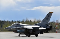 A U.S. Air Force F-16 Fighting Falcon pilot assigned to the 80th Fighter Squadron out of Kunsan Air Base, Republic of Korea, taxis down the Eielson Air Force Base, Alaska, flight line May 5, 2016, in preparation for a RED FLAG-Alaska (RF-A) 16-1 afternoon mission. The Joint Pacific Alaska Range Complex provides units like the Wolf Pack access to a realistic training environment and allows commanders to train for full spectrum engagements ranging from individual skills to complex, large-scale joint engagements. (U.S. Air Force photo by Master Sgt. Karen J. Tomasik/Released)