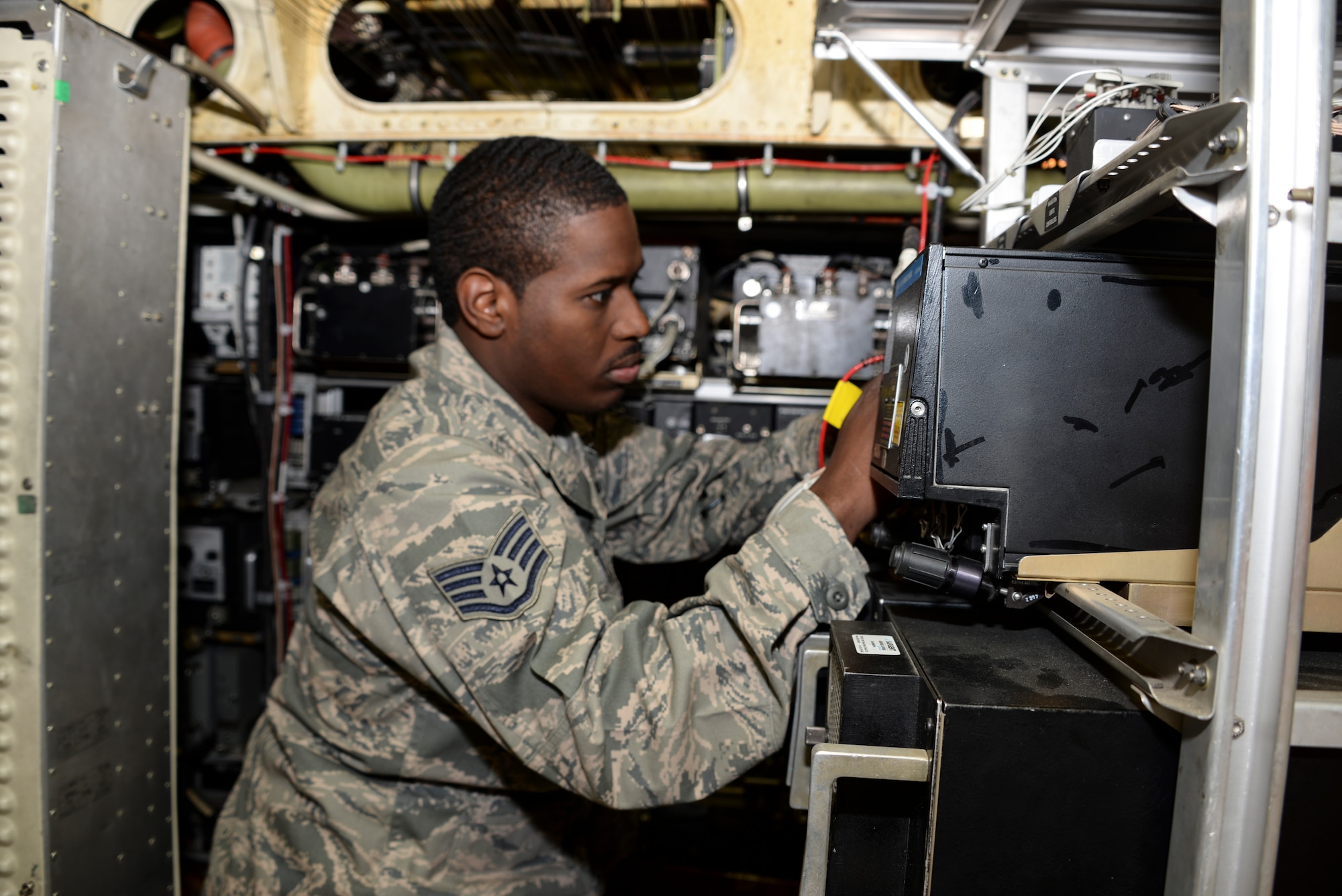 Staff Sgt. Terrell Cole, 660th Aircraft Maintenance Squadron communication/navigation mission systems craftsman, repairs a transponder underneath the flight deck of a KC-10 May 11 at Travis Air Force Base, Calif. (U.S. Air Force photo by Senior Airman Amber Carter)