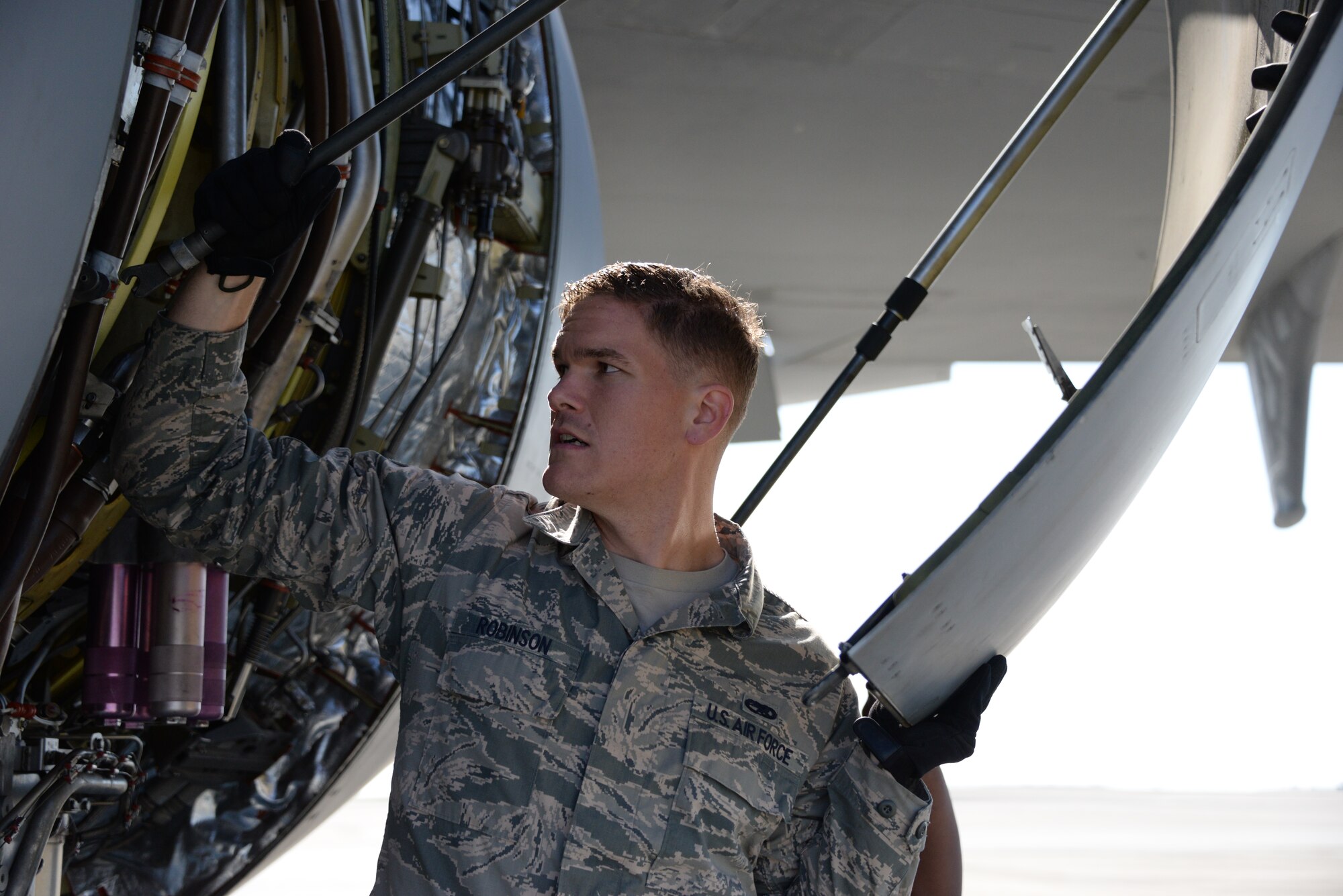 Staff Sgt. Allyn Robinson, 660th AMXS electrician, repairs engine No. 1 of a KC-10 Extender May 10 at Travis Air Force Base, California. (U.S. Air Force photo by Senior Airman Amber Carter)