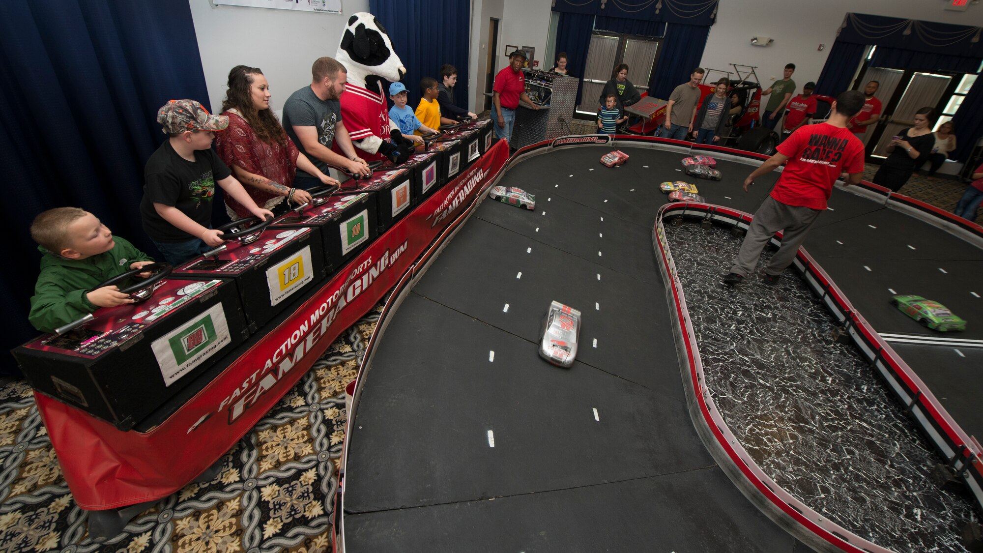Team Dover NASCAR fans drive remotely control stock cars at the Dover Air Force Base Race Weekend Social at the Landings on Dover AFB, Del. This event occurs every Friday prior to Dover International Speedway’s spring and fall races. (U.S. Air Force photo/Senior Airman Zachary Cacicia)