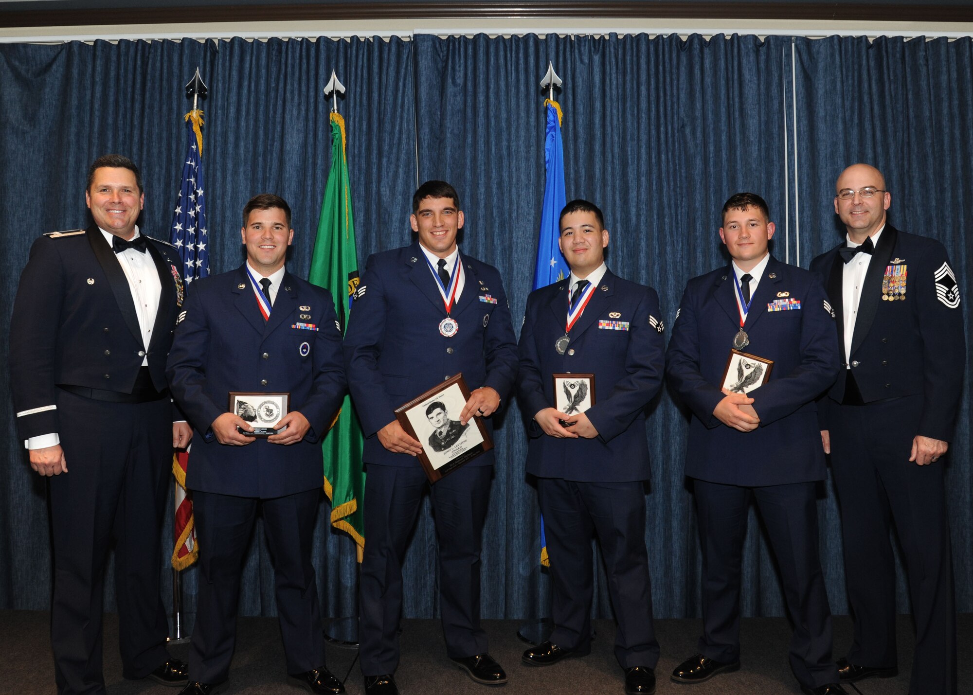 Airmen of Airman Leadership School Class 16 Delta, who earned top honors, pose for a photo with Col. Matthew Fritz, 92nd Air Refueling Wing vice commander, and Chief Master Sgt. James Fitch, 92nd Operations Group superintendent, May 12, 2016, at Fairchild Air Force Base, Wash. ALS is a five-week course that focuses on leadership abilities, profession of arms and effective communication in the workplace. (U.S. Air Force photo/Senior Airman Sam Fogleman)