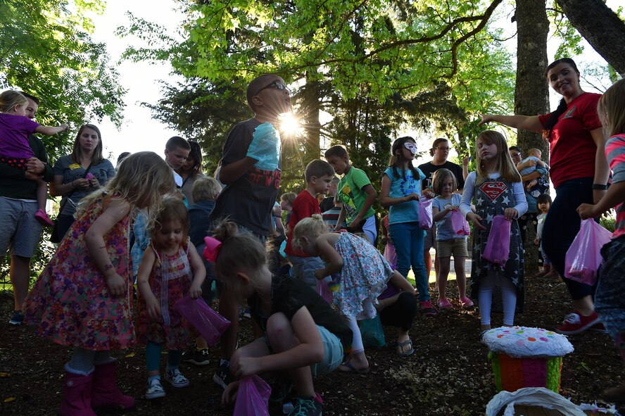 Children pick up candy from a piñata at the Team McChord Deployed Families Dinner May 10, 2016, at the Chapel Support Center on Joint Base Lewis-McChord, Wash. More than 25 children participated in the piñata event and they all received a free toy at the event. (U.S. Air Force photo/Staff Sgt. Naomi Shipley) 