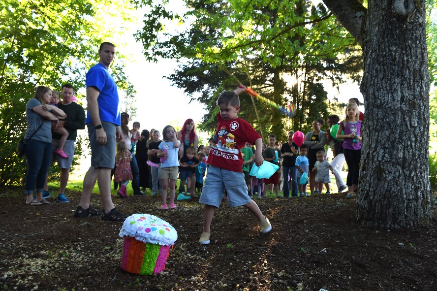 A child hits a piñata at the Team McChord Families Dinner May 10, 2016, at the Chapel Support Center on Joint Base Lewis-McChord, Wash. Dozens of children participated in the activities at the event, which included coloring and games. (U.S. Air Force photo/Staff Sgt. Naomi Shipley)