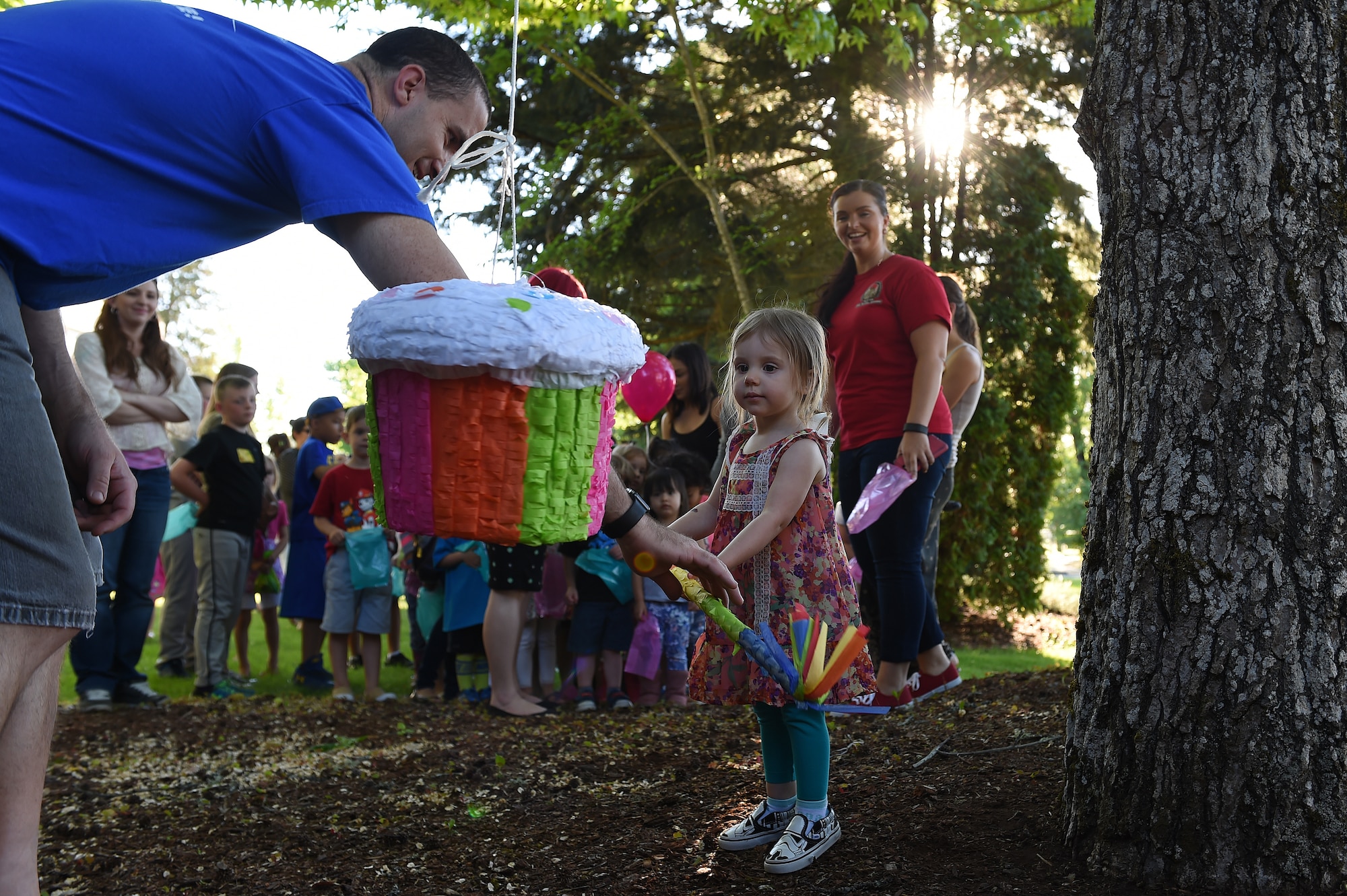 A child prepares to hit a piñata at the Team McChord Deployed Families Dinner May 10, 2016, at the Chapel Support Center on Joint Base Lewis-McChord, Wash. The dinner is hosted quarterly to support families of deployed members. (U.S. Air Force photo/Staff Sgt. Naomi Shipley)