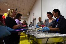 Team McChord leadership and volunteers serve food to the families attending the Team McChord Deployed Families Dinner May 10, 2016, at the Chapel Support Center on Joint Base Lewis-McChord, Wash. More than 100 family members of deployed service members came out to attend the event. (U.S. Air Force photo/Staff Sgt. Naomi Shipley)