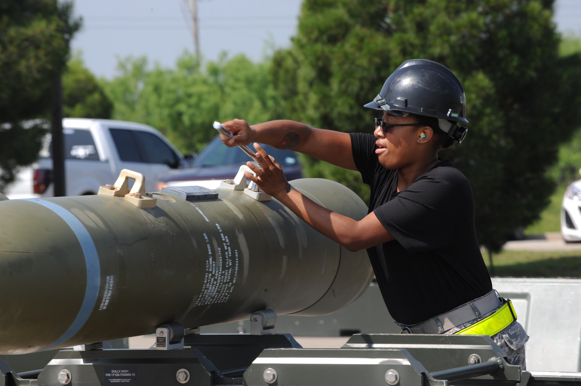 U.S. Air Force Airman 1st Class Tamarria Hudson, 7th Munitions Squadron conventional maintenance crew member, performs a lug removal of an inert GBU-31 V3 joint direct attack munition as part of a bomb build competition April 29, 2016, at Dyess Air Force Base, Texas. The competition not only challenged the participants’ individual skills but also their ability to work as a team. (U.S. Air Force photo by Airman 1st Class Rebecca Van Syoc/Released)