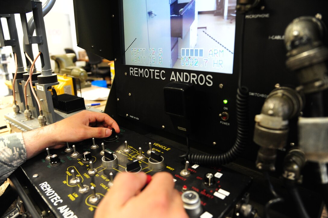 U.S. Air Force Airman 1st Class Conner Walsh, a 509th Civil Engineer Squadron explosive ordnance disposal (EOD) team member, uses an F6A robot controller at Whiteman Air Force Base, Mo., May 10, 2016. The robots are the primary means of handling explosive ordnances to eliminate potential harm to EOD members. (U.S. Air Force photo by Airman 1st Class Keenan Berry)