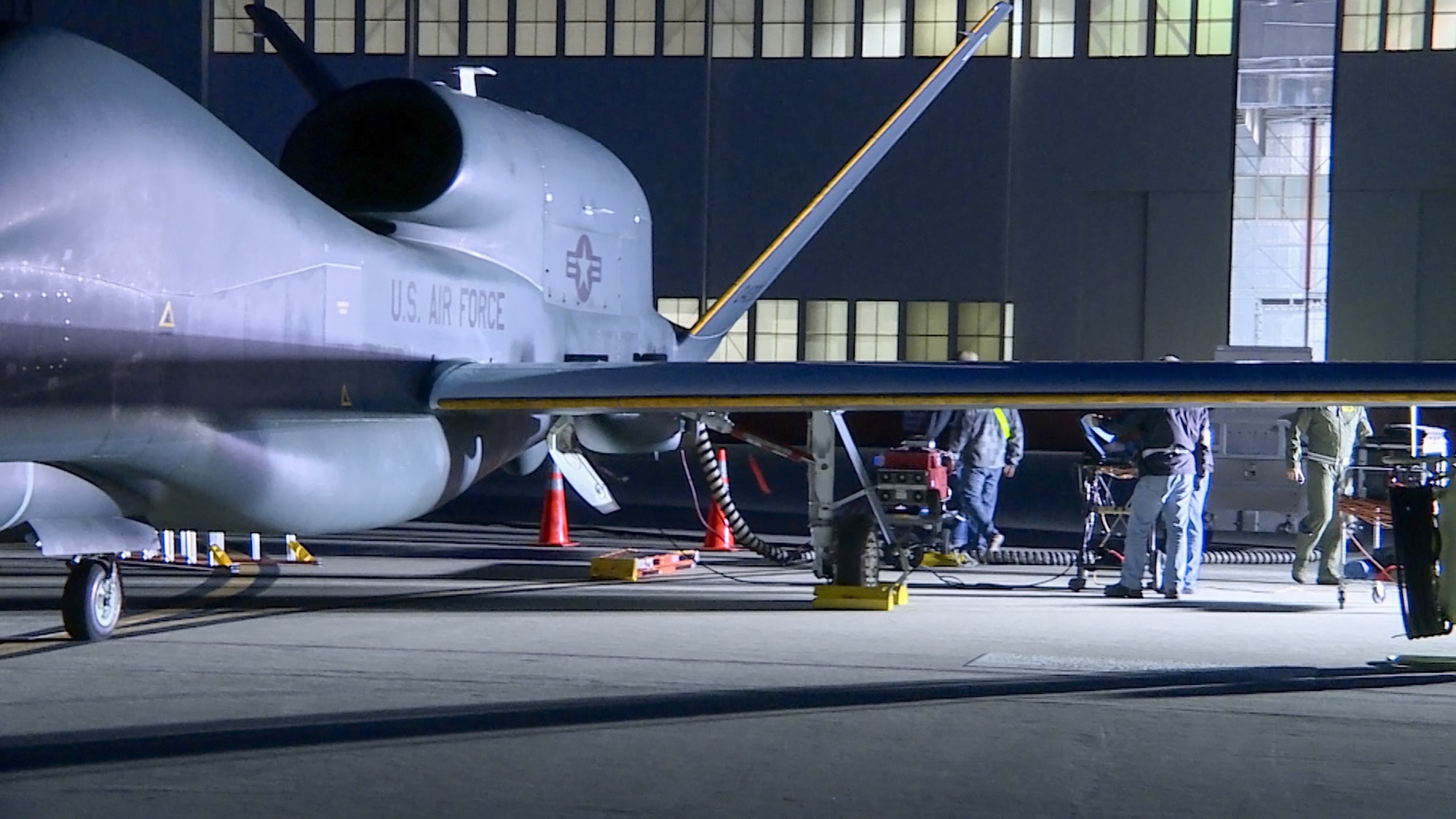 Global Vigilance Combined Test Force members prepare a Global Hawk remotely piloted vehicle to perform icing test flights. The aircraft was fitted with a 3-D printed nylon structure to duplicate the weight and drag of ice forming on wings and tail. (U.S. Air Force photo by Chris Higgins.)