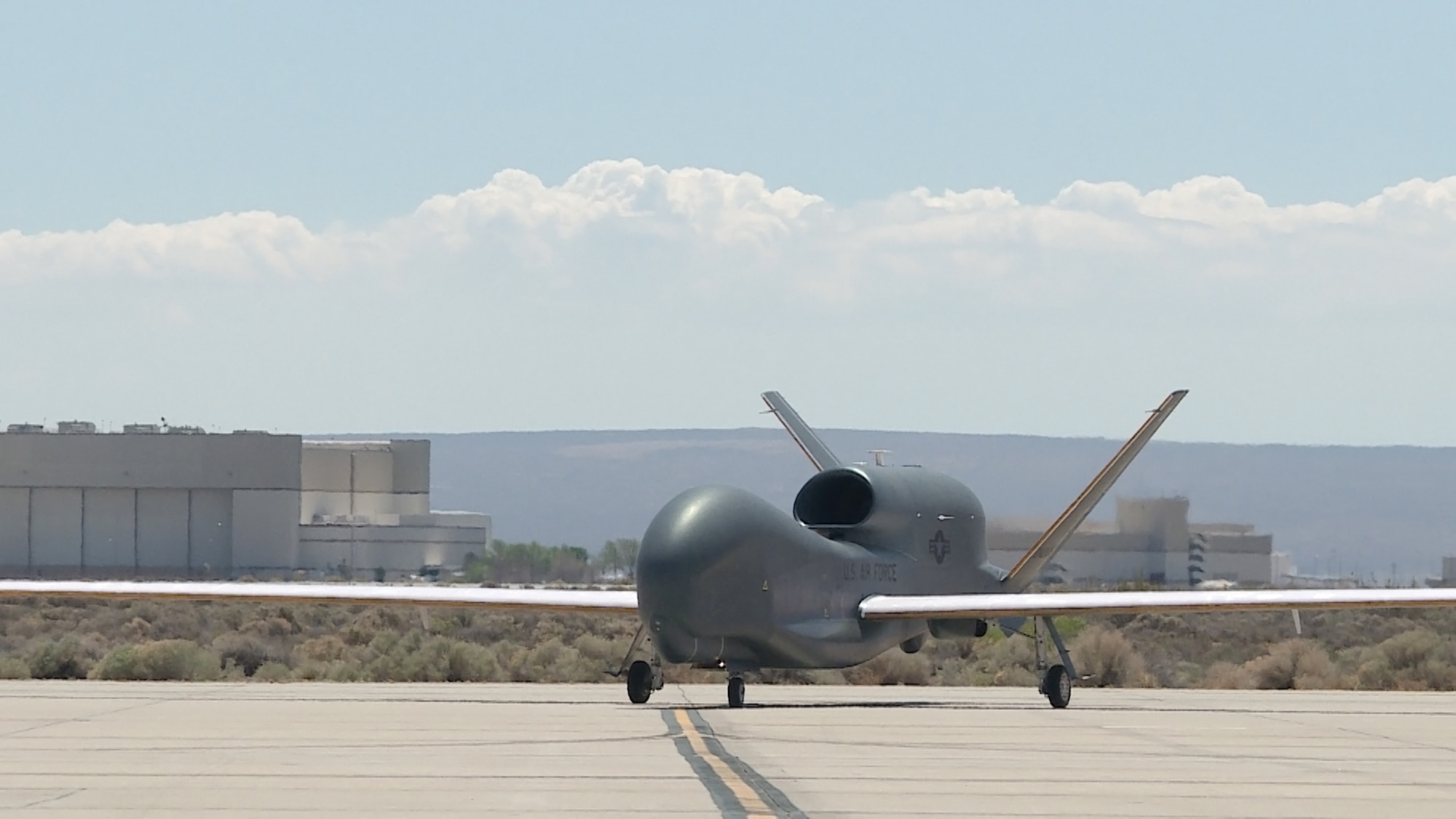 A Global Hawk remotely piloted vehicle taxis on the Edwards Air Force Base flightline during an icing test mission. The aircraft was fitted with a 3-D printed nylon structure to duplicate the weight and drag of ice forming on wings and tail. (U.S. Air Force photo by Chris Higgins.)