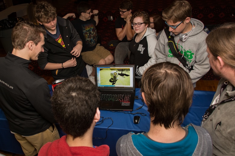 Students gather around to watch a gaming demonstration during the Full Throttle STEM® at Eldora Day May 10. The event, hosted by the 711th Human Performance Wing and Eldora Speedway, brought in more than 200 local high school students and showcased their STEM projects. (U.S. Air Force photo/Richard Eldridge)
