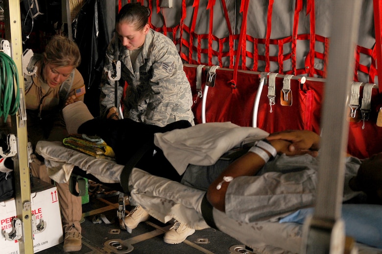 Staff Sgt. Laura Zulkosky, 455th Expeditionary Aeromedical Evacuation Flight 3rd medical technician, adjusts a patient on a litter for transport to Bagram Airfield, Afghanistan, June 28, 2011. (U.S. Air Force photo/Senior Airman Krista Rose)