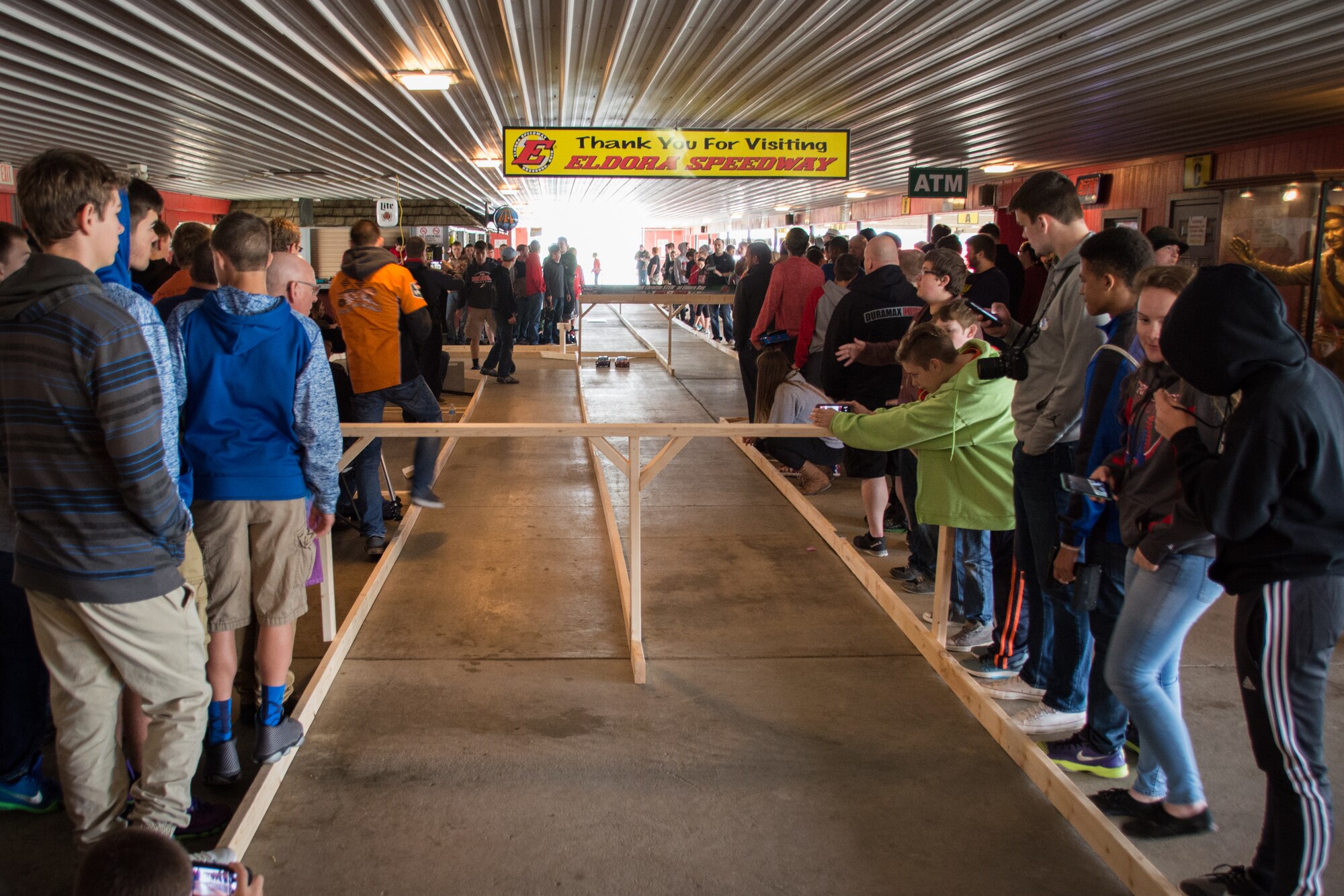 Students stand around the racetrack waiting for the remote controlled car races to begin during the Full Throttle STEM® at Eldora Day May 10. (U.S. Air Force photo/Richard Eldridge)