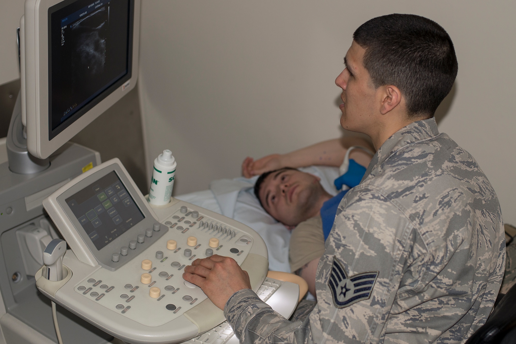 Staff Sgt. Manuel Gonzales, 374th Surgical Operations Squadron ultrasound technician, conducts a carotid arterial ultrasound at Yokota Air Base, Japan, May 11, 2016. In addition to identifying internal injuries with X-rays and ultrasound, the diagnostic imaging flight also supports obstetrics, gynecology and orthotics. (U.S. Air Force photo by Senior Airman David C. Danford/Released)