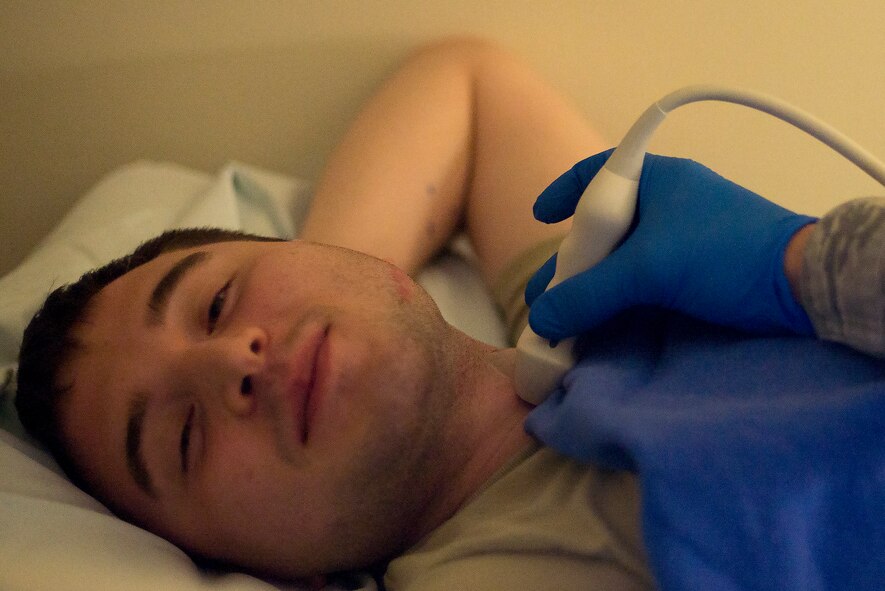 A patient has an ultrasonic transducer placed against their neck during a carotid arterial ultrasound at Yokota Air Base, Japan, May 11, 2016. The transducer works on similar principals to radar and sonar systems, converting ultrasound waves into electrical signals. (U.S. Air Force photo by Senior Airman David C. Danford/Released)