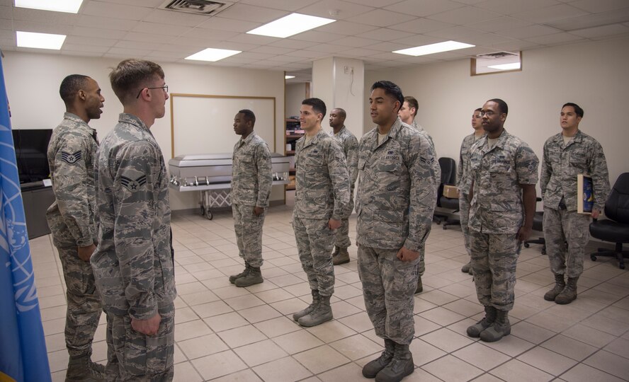 Honor Guardsmen stand at attention and recite the Honor Guard Charge during training at Yokota Air Base, Japan, May 11, 2016. The charge is recited after the end of each training session. (U.S. Air Force photo by Staff Sgt. Michael Washburn/Released)
