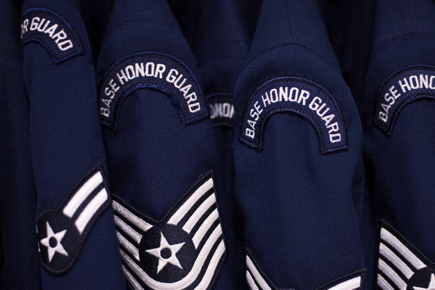 Service dress jackets, belonging to the Yokota Honor Guard, hang in a closet at Yokota Air Base, Japan, May 11, 2016. For a complete Honor Guard uniform, the cost is roughly $850 dollars. (U.S. Air Force photo by Staff Sgt. Michael Washburn/Released)