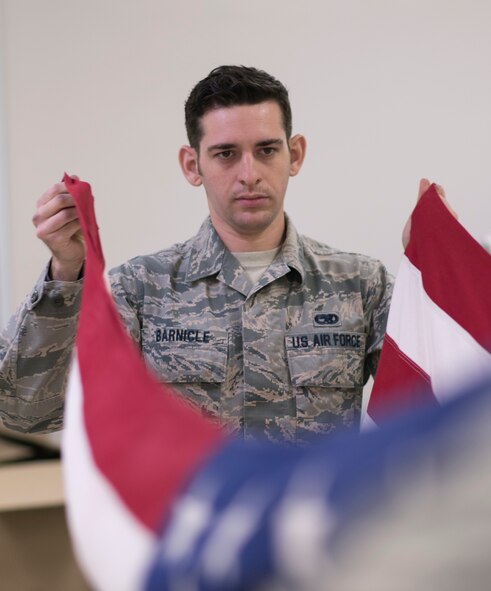 Staff Sgt. Patrick Barnicle, Yokota Honor Guard, holds an American flag during honor guard training at Yokota Air Base, Japan, May 11, 2016. New trainees join Honor Guard every quarter, ensuring they have enough Airmen to perform at ceremonies throughout the year. (U.S. Air Force photo by Staff Sgt. Michael Washburn/Released)