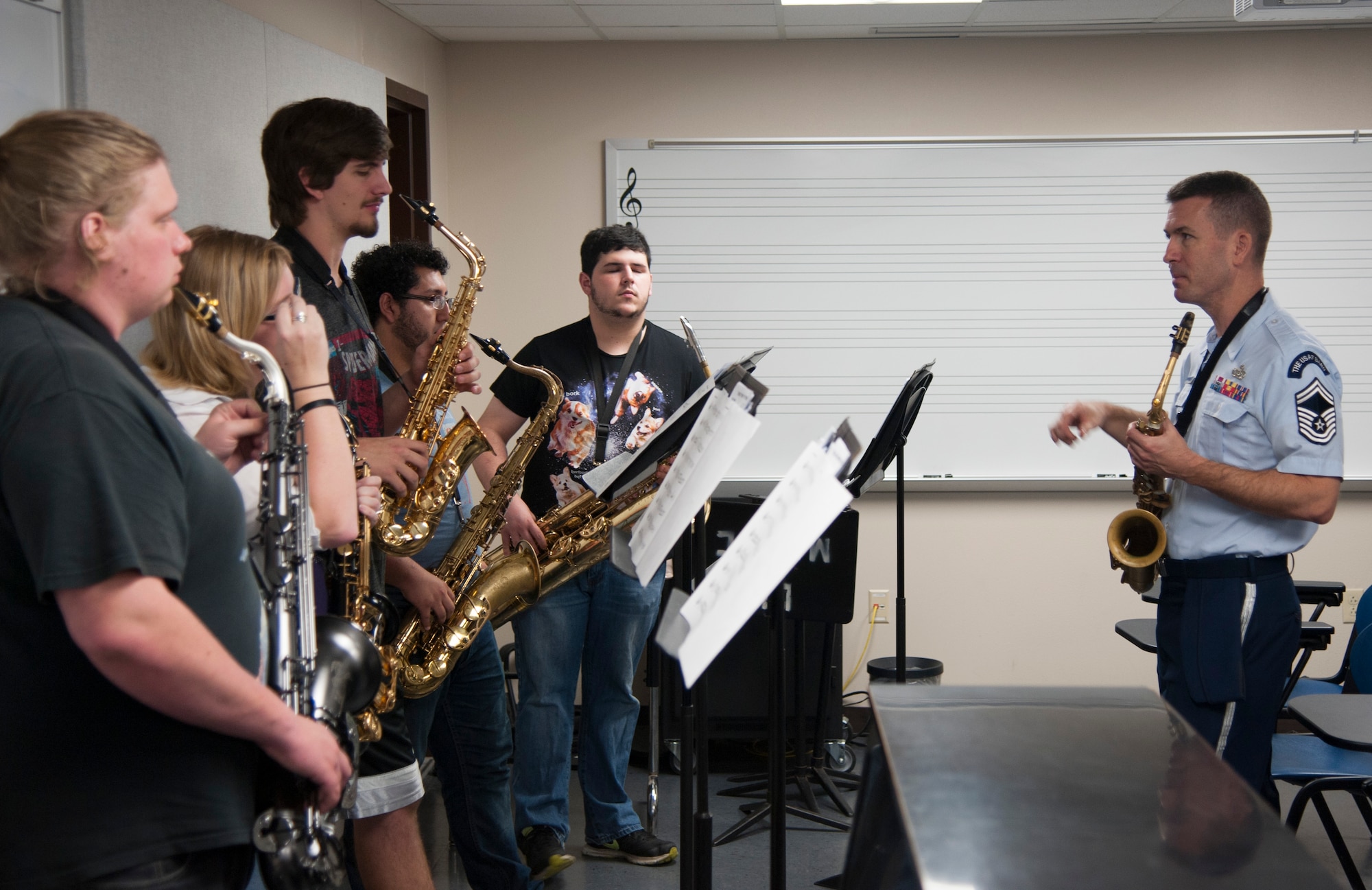 Senior Master Sgt. Tyler Kuebler, the director of the Airmen of Note and a saxophone player, teaches some of the finer points of playing saxophone for a big jazz ensemble during an Advancing Innovation through Music Outreach April 25 at Lamar University in Beaumont, Texas. (U.S. Air Force photo by Tech. Sgt. James Bolinger)