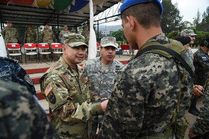 U.S. Army Brig. Gen. James P. Wong (left), deputy commanding general, Army National Guard of U.S. Army South, congratulates a graduate of a Task Force-Caiman-sponsored Regionally Aligned Forces-Central America training course in Tamara, Honduras, April 30, 2016. During the event, Wong spoke about the importance of the training to all involved and congratulated the newest graduates. (U.S. Air Force photo by Staff Sgt. Siuta B. Ika)