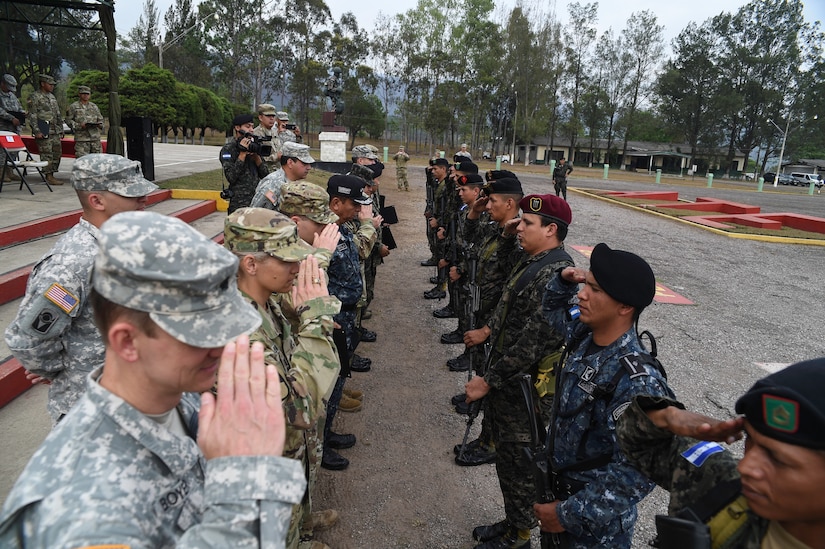 Leadership from U.S. Army South, Regionally Aligned Forces-Central America, Joint Task Force-Bravo and the Honduran Army salute the newest graduates of a Task Force-Caiman-sponsored RAF-CENTAM training course in Tamara, Honduras, April 30, 2016. Task Force-Caiman conducts counter-transnational organized crime training in Guatemala, Honduras and El Salvador to improve partner nation capabilities and regional security. (U.S. Air Force photo by Staff Sgt. Siuta B. Ika)