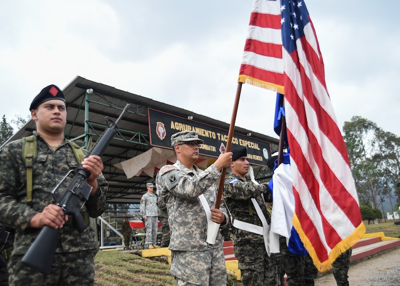 Members of Regionally Aligned Forces-Central America and the Honduran Army perform color guard detail during a Task Force-Caiman-sponsored RAF-CENTAM training course closing ceremony in Tamara, Honduras, April 30, 2016. The closing ceremony recognized members of the Honduran Army and TIGRES (Tropa de Inteligencia y Grupos de Respuesta Especial de Seguridad de la Policía Nacional) Special Police who completed special training with Task Force-Caiman. (U.S. Air Force photo by Staff Sgt. Siuta B. Ika)