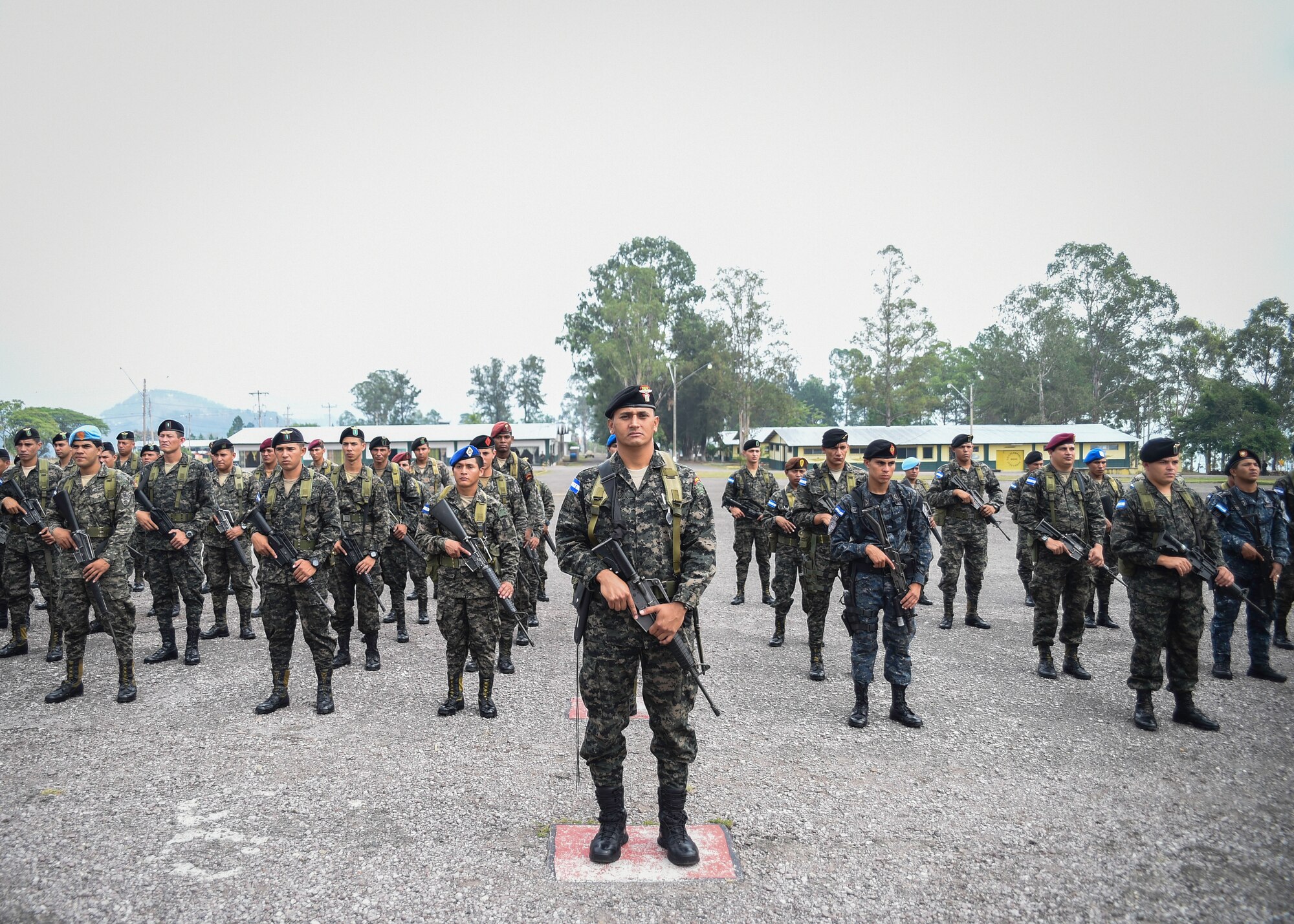 Members of the Honduran Army and TIGRES (Tropa de Inteligencia y Grupos de Respuesta Especial de Seguridad de la Policía Nacional) Special Police stand in formation during a Task Force-Caiman-sponsored Regionally Aligned Forces-Central America training closing ceremony in Tamara, Honduras, April 30, 2016. Throughout the three-week course, members of the 53rd Infantry Brigade Combat Team of the Florida Army National Guard trained the Hondurans on marksmanship, patrolling, battle drills, urban operations and other tasks designed to enhance their ability to counter transnational organized crime. (U.S. Air Force photo by Staff Sgt. Siuta B. Ika)