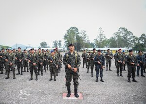 Members of the Honduran Army and TIGRES (Tropa de Inteligencia y Grupos de Respuesta Especial de Seguridad de la Policía Nacional) Special Police stand in formation during a Task Force-Caiman-sponsored Regionally Aligned Forces-Central America training closing ceremony in Tamara, Honduras, April 30, 2016. Throughout the three-week course, members of the 53rd Infantry Brigade Combat Team of the Florida Army National Guard trained the Hondurans on marksmanship, patrolling, battle drills, urban operations and other tasks designed to enhance their ability to counter transnational organized crime. (U.S. Air Force photo by Staff Sgt. Siuta B. Ika)