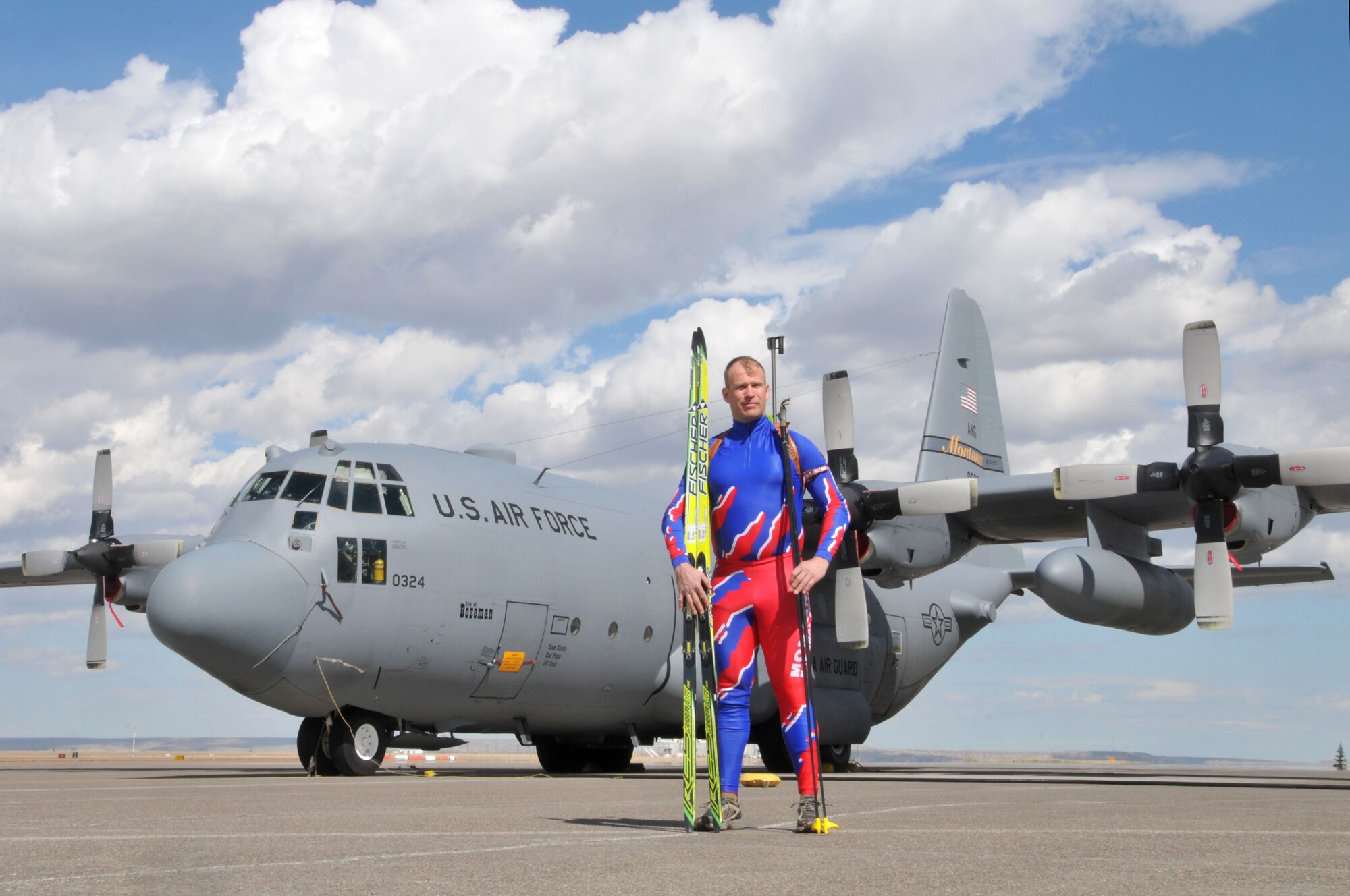Staff Sgt. Ersnt Visscher, 120th Airlift Wing crew chief, poses in front of a C-130 Hercules for a photo with his biathlon skis, poles and rifle April 3, 2014. Visscher is the longest serving member of the Montana National Guard Biathlon team and only member who serves as a member of the Montana Air National Guard. (U.S. Air National Guard photo/Staff Sgt. Lindsey Soulsby)