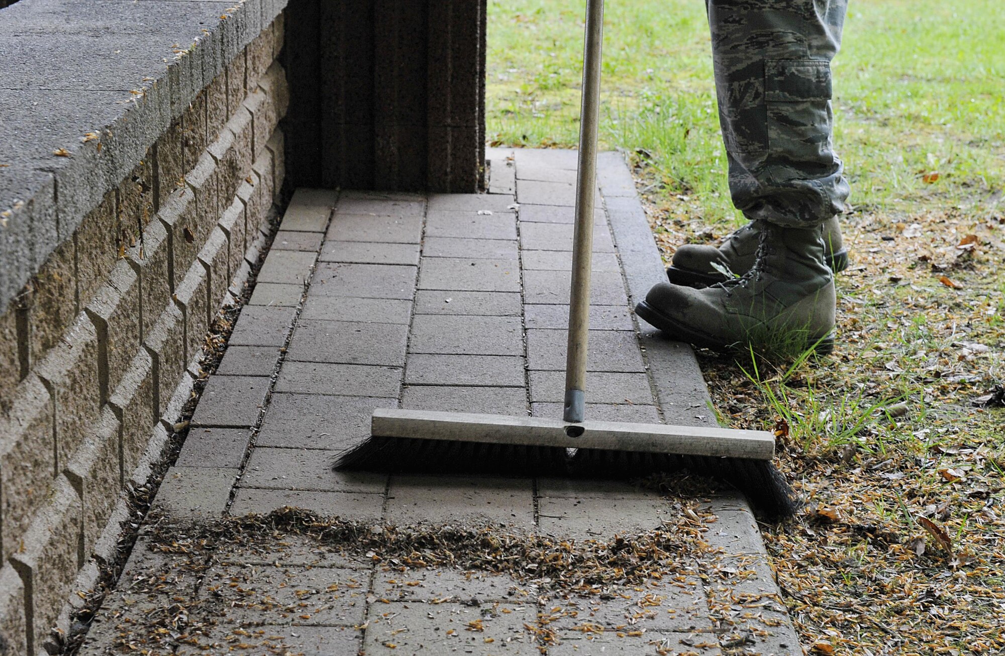 Tech. Sgt. John Paul Diaz, 435th Air Ground Operations Wing chief of safety, sweeps during a base pride day May 10, 2016, at Ramstein Air Base, Germany. Base pride happens twice a year; in spring and fall, and is a way Airmen take care of Ramstein to ensure cleanliness and professionalism. (U.S. Air Force photo/Senior Airman Larissa Greatwood)