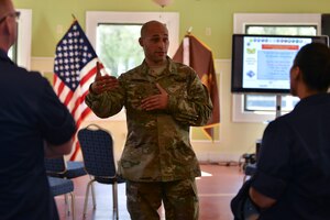 Chief Warrant Officer 3 Samuel Garrett, president of the Warrant Officer Association Hampton Roads Chapter, speaks with U.S. Coast Guard warrant officers during the chapter’s quarterly workshop at Fort Eustis, Va., April 14, 2016. The chapter focuses on fostering relationships and building mentorship opportunities with current and future warrant officers from all services. (U.S. Air Force photo by Staff Sgt. Natasha Stannard)