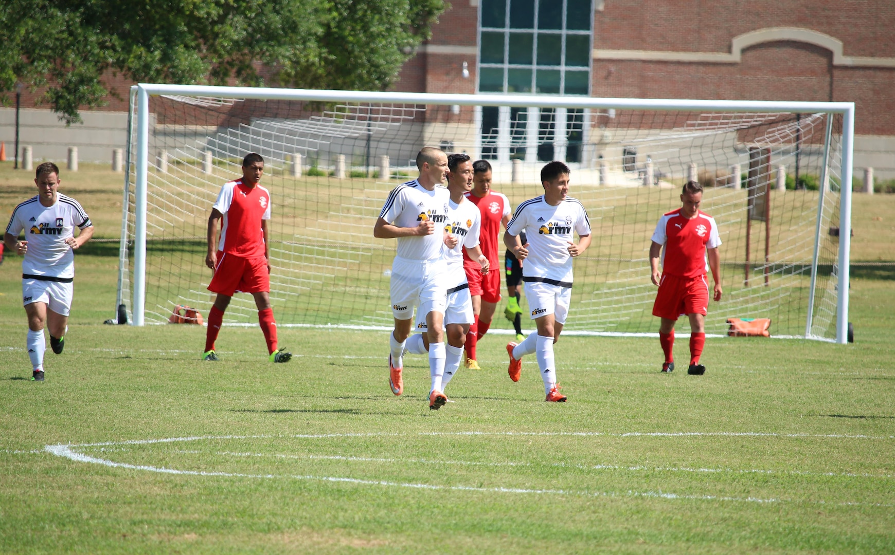 Fort Benning, Ga. - Army Sgt. Joseph Karslo (third from left), scores Army's second goal in the consolation match of the 2016 Armed Forces Men's Soccer Championship hosted at Fort Benning, Ga from 6-14 May 2016.  Marine Corps would go on to win the contest 3-2 to take third place.